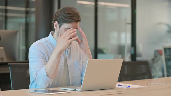 Man with Laptop Having Headache