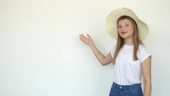 Calm Little Girl Standing in Swimming Wear and Panama Hat Isolated Over White Background