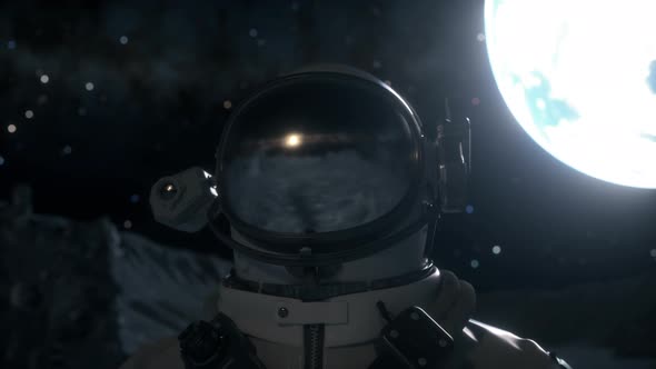 Astronaut Stands on the Surface of the Moon Among Craters Against the Backdrop of the Planet Earth