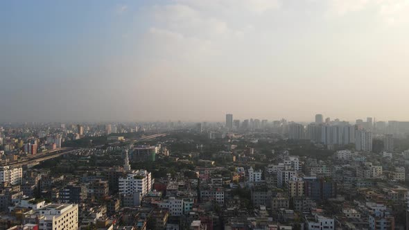 Descending drone shot with views of Dhaka's polluted skyline, Bangladesh
