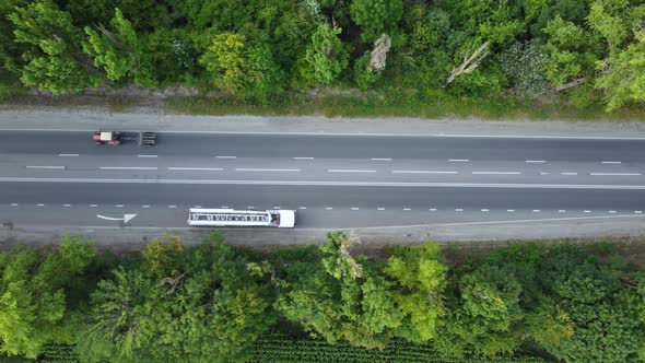 Truck Tractor and Cars View From Above on the Asphalt Road High Above the Trees