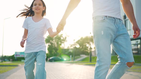 Dad and Daughter Walk Around Their Area at Sunset