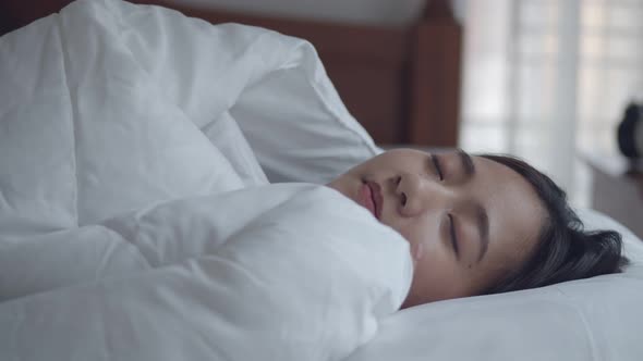 Young Asian women sleeping well comfortably in the bedroom at home.