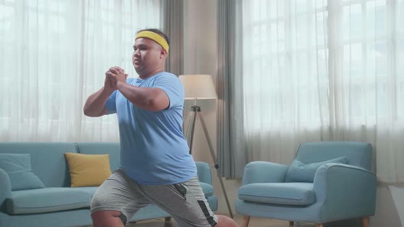 Fat Asian Man Doing Yoga On Mat  At Home