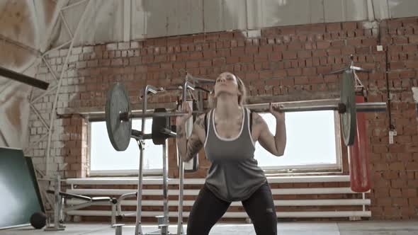 Muscular Woman Doing Barbell Lunges and Squats