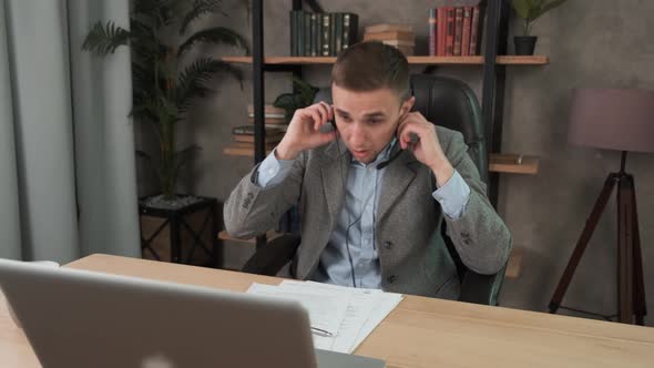 Exhausted Young Man. Tired Overworked Guy Feeling Eye Strain After Using Computer Working From Home