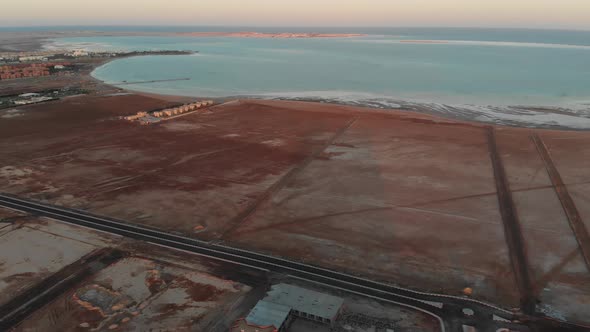 Flight over the desert in Egypt. The building is being built in the desert. Empty highways. Egypt.