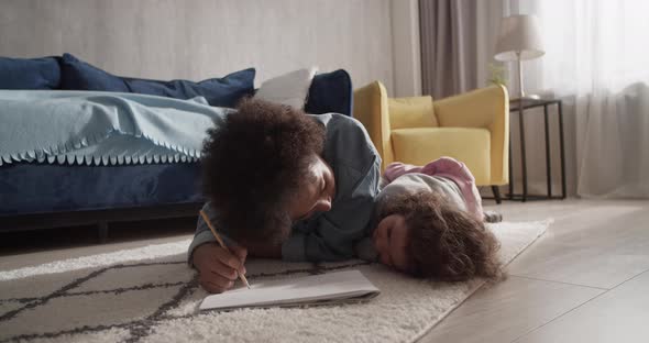 Mother and Daughter Drawing on Floor