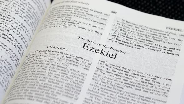 Close Up Shot of  Bible Page Turning to the book of Ezekiel