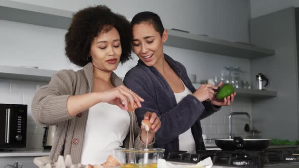 Lesbian couple preparing breakfast in kitchen
