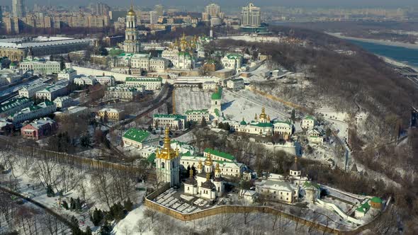 Beautiful winter top view of the Kiev-Pechersk Lavra. Many churches in the snow.