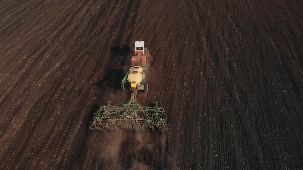 Planting Seeds in Dust Ground. Spring Agricultural Work. Aerial Top View. Cultivated Field on Seeds