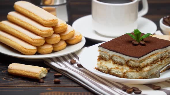 Portion of Traditional Italian Tiramisu Dessert Cup of Espresso Mocha and Coffee Beans