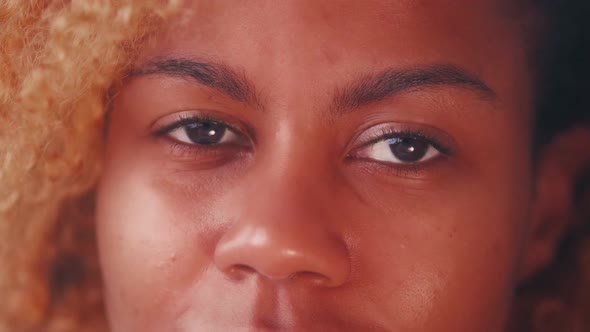 Close Up African American Woman Blinking Brown Color Eyes Looking at Camera