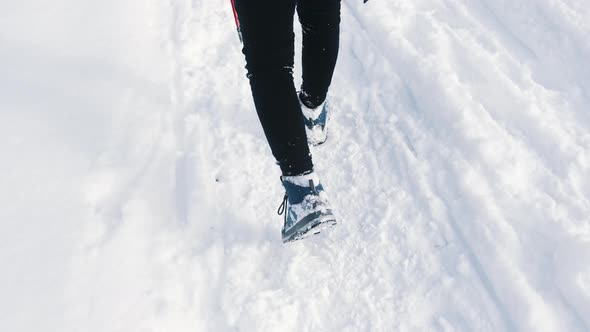 Young Person Walking on the Snow