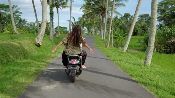 Happy Couple Tripping By Motorcycle on Tropical Road at Sunset Time. Outdoor Shot of Young Couple