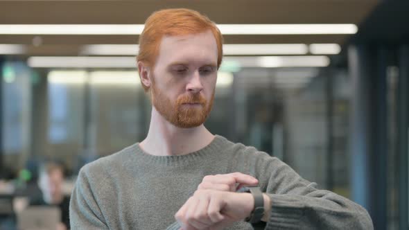 Portrait of Young Man Using Smart Watch