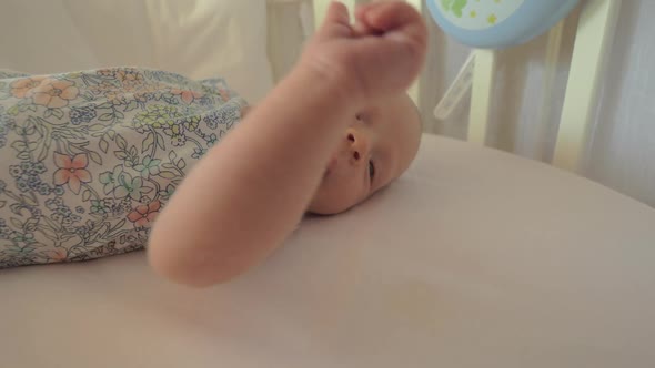 Newborn Girl in Crib Before Daytime Sleep