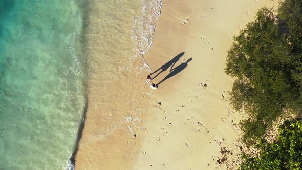 Beautiful couple on honeymoon vacation enjoy luxury on beach on clean white sand background 4K