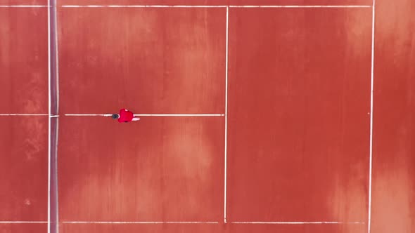 Top View of a Tennis Court Getting Marked By a Man