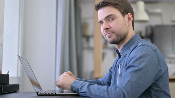 Beard Young Man Showing Thumbs Down in Office