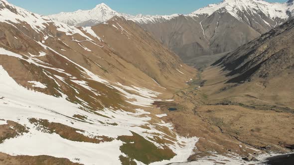 Tilt Down View Of Juta Valley With Melting Snow