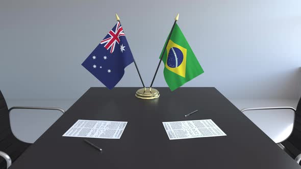 Flags of Australia and Brazil on the Table