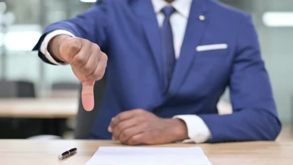 Hand of African Businessman Showing Thumbs Down 