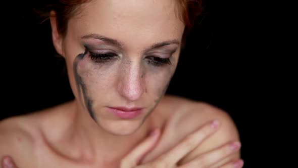 Young Woman Crying on Black Background