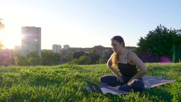 Young yoga teacher during video call at viewpoint