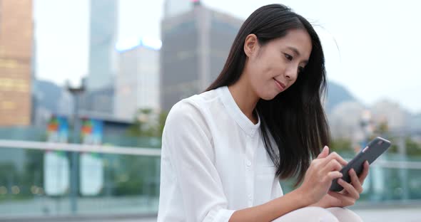 Business woman use of mobile phone in city at night