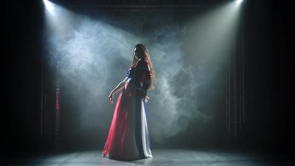 Burning Brunette in Sexy Suit in the Color of the English Flag and Rhinestones Is Dancing. Night