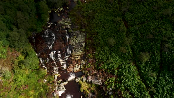 Aerial view Waterfall in Snowdonia National Park, Wales. Sunset following the footage.