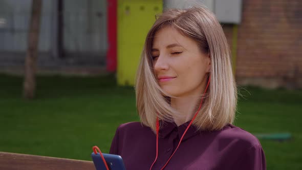 Woman Using Headphones to listen to Music,