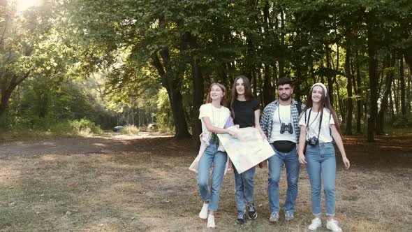 Group of Tourists Searching for Places on Their Map Outdoors