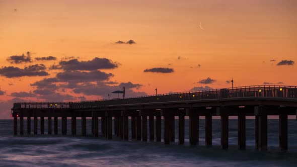 The Crescent moon rises over the pier in Miami