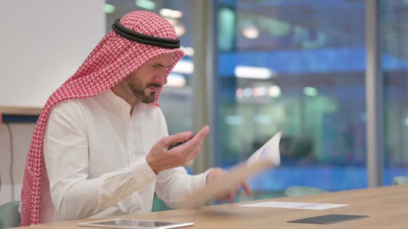Upset Arab Businessman Having Loss on Documents