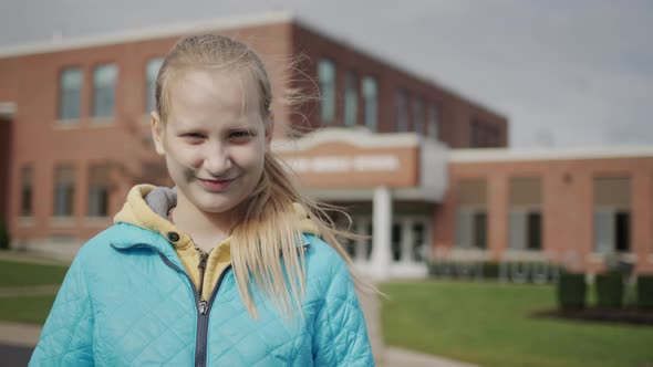 Portrait of an American Student in Front of a High School Building