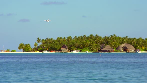 View of a seaplane landing at a tropical island in the Maldives.