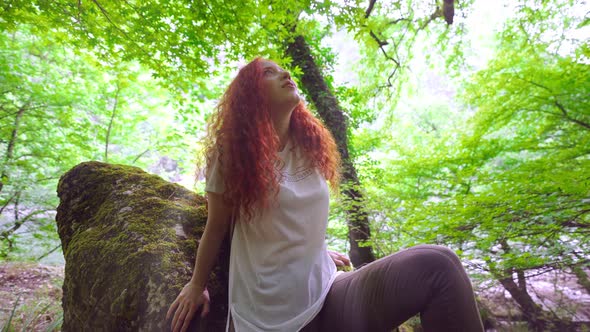 Happy Woman in Forest Enjoying Nature