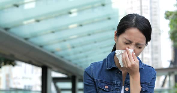 Woman Sneeze at Outdoor