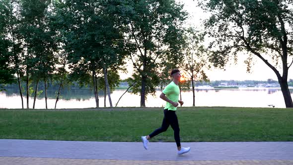 Sport Athlete in Sportswear Running at River Outdoor Jogging