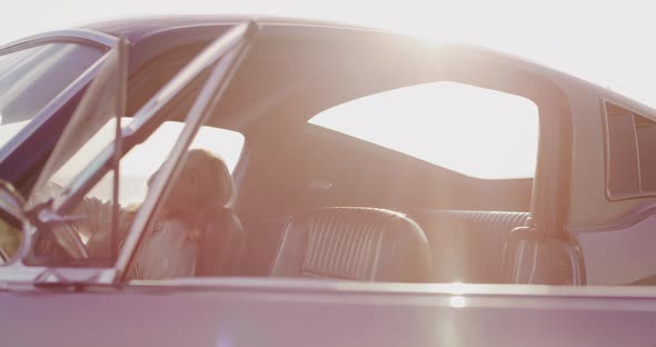 Beautiful woman sitting in a vintage car