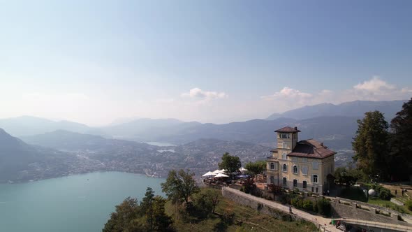 Establish city Lugano behind de ristorante monte brè, epic city panorama, aerial