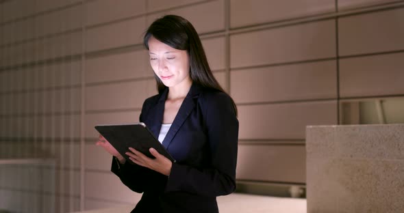 Asian Businesswoman use of tablet computer at night