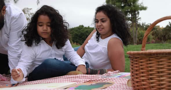 Indian parents having fun at city park painting with children - Family, summer and love