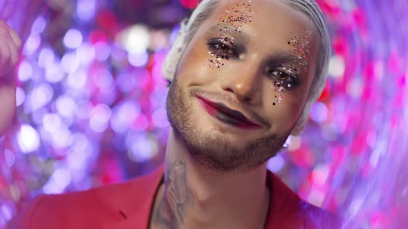 Portrait of Man with Make-Up with Glitter Posing