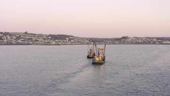 Fishing Trawlers Returning to Port at Sunrise