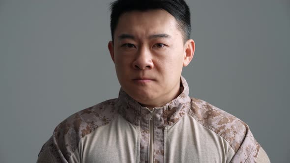 Strong military Asian man looking at the camera