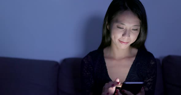 Asian Woman Look at Mobile Phone in The Evening